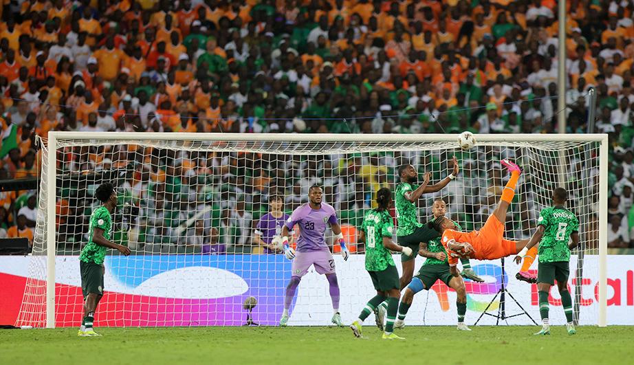 Action de football près des cages de but - voir description détaillée ci-après