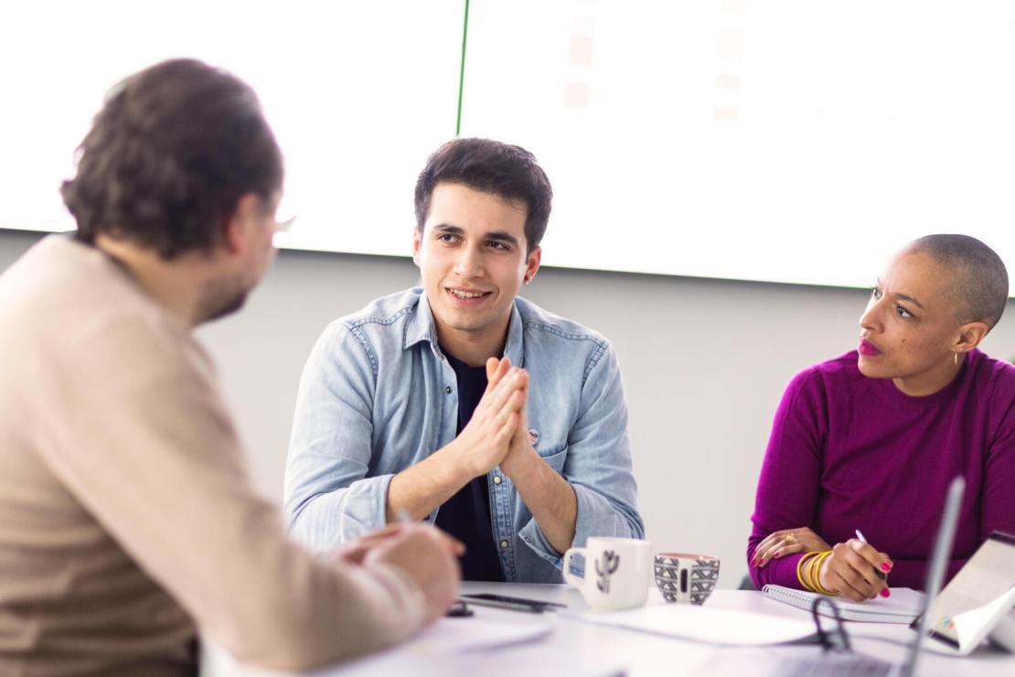 group of employees talking during a meeting